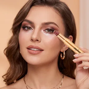 Close-up view of model applying Zephoco shimmery eyeshadow stick for a professional makeup look.