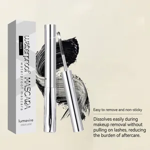 Close-up of lumavire waterproof mascara wand, applicator brush and black product smear