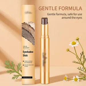 Macro view of golden-brown shimmer dual-color eyeshadow stick and packaging