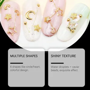 Close-up of gold star and moon nail art decorations on pastel-colored nails