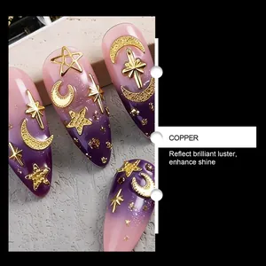 Macro detail of golden moon and star nail art charms made of copper on purple gradient manicured nails