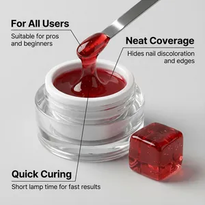 Macro detail of translucent berry red jelly nail gel with metal spatula applicator