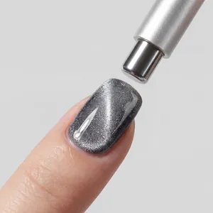 Macro view of a 3-in-1 nail magnet pen creating a grey cat-eye effect on a nail