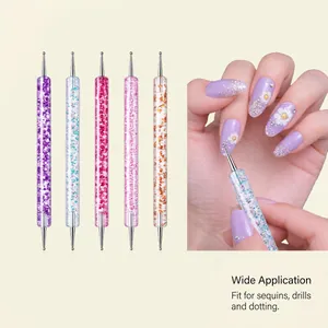 Close-up of a dual-ended nail dotting pen used for intricate purple floral manicure.