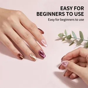 Detailed view of manicured hands with cat eye gel nail polish in shimmering colors