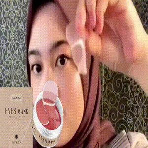 Close-up view of a woman applying a nourishing collagen eye mask patch for skin care