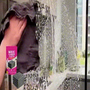 Detail shot of a microfiber magic cleaning cloth wiping a soapy glass mirror surface