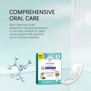 Detail view of JAYSUING coconut oil mint whitening strips and application strips on glass.