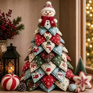 Detailed view of handmade quilted fabric Christmas tree with snowman topper