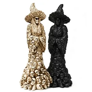 Detailed macro shot of two skull witch resin statues in bone and black finishes.