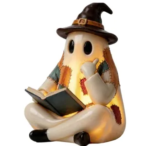 Detailed view of glowing patchwork ghost figurine wearing a wizard hat for Halloween decor