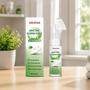 Jakehoe white shoe cleaning bubble 100ml with brush head and box on a bright wooden table.