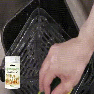 Detailed view showing the efficient removal of grease from an air fryer basket using powder.