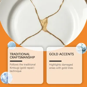 Detail of ceramic plate repaired with golden Kintsugi glue showing traditional gold lines.