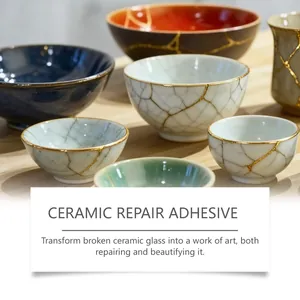 Close-up of ceramics repaired with gold kintsugi adhesive for an artistic finish.