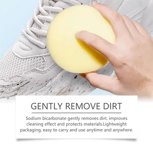 Close-up of a yellow sponge gently removing dirt from a white sneaker shoe surface.