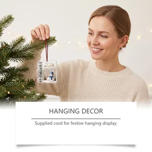Acrylic Christmas money holder ornament hanging on a tree with a red festive cord.