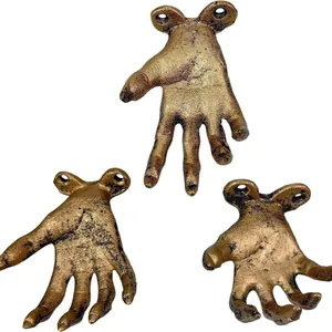 Detailed view of three vintage bronze resin hand-shaped wall hooks for home decor