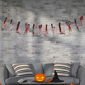 Halloween party banner with bloody weapon cutouts on a brick wall