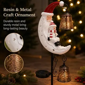 Close-up detail of solar Christmas garden stake light with Santa moon and snowman design