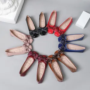 Detailed view of women's ballet flat shoes in various colors with bow decorations.