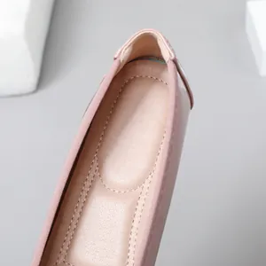 Close-up view of the heel and soft insole of a pink patent leather flat shoe.