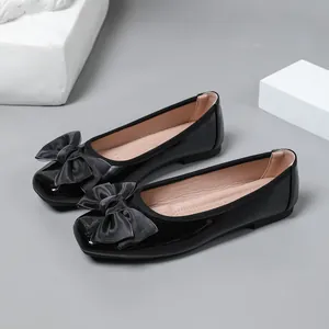 Elegant black ballet flats with satin bow detail, comfortable slip-on style for women.