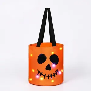 Detailed view of Halloween candy bucket with glowing LED lights and skull face