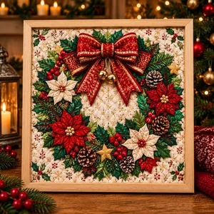 Close-up of Christmas fabric art painting featuring a wreath and red bow in a wooden frame