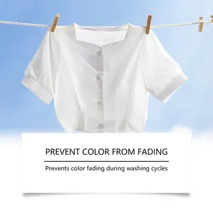 White blouse drying on a line under a blue sky, showcasing color-fade protection detail.