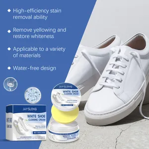 Detail view of white shoe cleaning cream kit with sponge and leather sneakers.