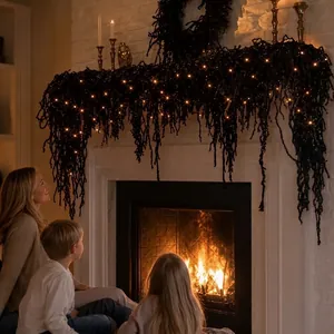 Festive black cedar garland with warm LED lights draped over a fireplace mantle.