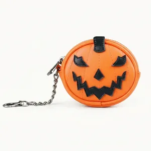 Primer plano de un mini monedero de calabaza de Halloween con cadena y clip de metal