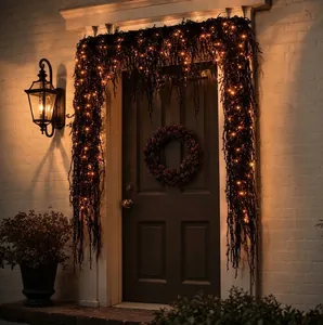 Decorative Halloween black willow garland with warm LED lights for outdoor door framing.