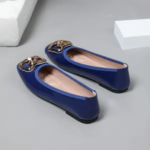 Elegant blue patent leather ballet flats featuring a stylish gold heart-shaped buckle detail