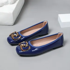 Elegant dark blue patent leather square toe ballet flats with a shiny gold heart buckle