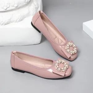 Elegant pink ballet flats featuring a sophisticated pearl-encrusted square buckle detail