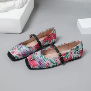 Detail view of floral pleated Mary Jane ballet flats with elegant buckled straps.