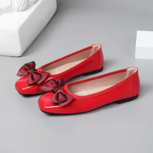 Elegant red patent leather ballet flats with a large dark red bow detail for women