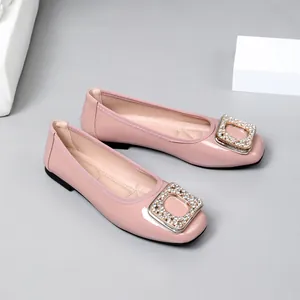 Elegant pink patent leather square toe flats with sparkling rhinestone buckle detail.