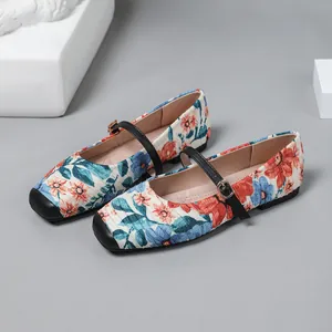 Detail of vintage French floral Mary Jane ballet flats featuring a black buckle strap