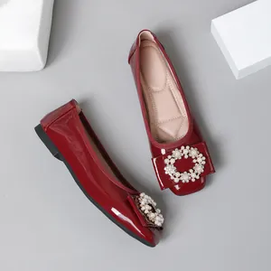Elegant wine red patent leather ballet flats with decorative pearl buckle detail