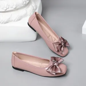 Elegant pink square toe ballet flats with a large bow and comfortable flat sole.