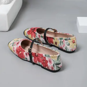 Close-up of vintage floral Mary Jane flats with elegant pleated fabric detail.