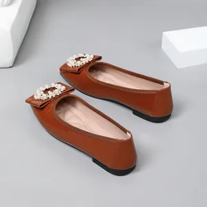 Elegant brown patent leather ballet flats with a sparkling pearl and rhinestone buckle.