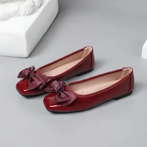 Elegant burgundy patent leather ballet flats with a decorative bow and square toe design
