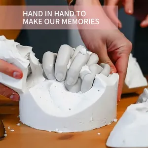 Close-up detail of peeling away the mold to reveal a DIY couple hand casting sculpture