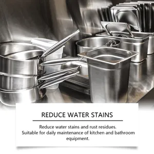 Polished stainless steel pots and pans cleaned with protective mirror cleaner paste
