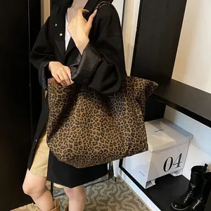 Large leopard print canvas tote bag carried by a model for a stylish casual look