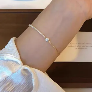 Elegant bracelet featuring delicate pearls and a sparkling zircon on a gold chain